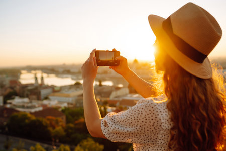 Travel in Europe. Young woman enjoys sunrise. The concept of travel, tourism, vacation and freedom.の写真素材