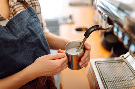 An experienced female bartender prepares a hot drink. Takeaway food. Professional coffee making.の写真素材