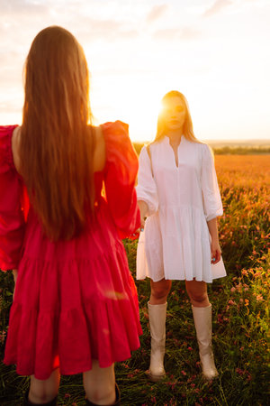 Two Beautiful woman in a field. Nature, fashion, vacation and lifestyle.の写真素材