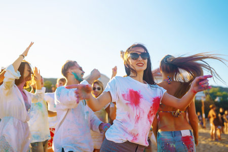 Teenagers Friends have fun at the holi festival. Beach Party. Celebrating traditional Indian spring...