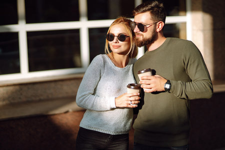 Happy couple spending time together drinking coffee having fun walking around morning city Lifestyleの写真素材