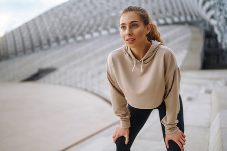 Young woman in sports outfit doing exercises outdoors in the morning. Concept of sports, yoga or...