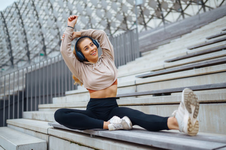Young woman in sports outfit doing exercises outdoors in the morning. Concept of sports, yoga or...