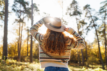 Outdoor atmospheric lifestyle. portrait of beautiful woman having fun in autumn forest. Warm autumnの写真素材