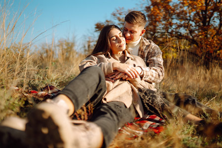 Happy couple in love newlyweds in casual clothes travel together, walk in autumn forest in nature.の写真素材