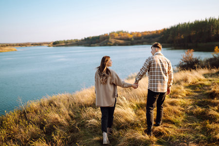 Stylish couple walking, enjoying autumn weather. People, lifestyle, relaxation and vacations conceptの写真素材