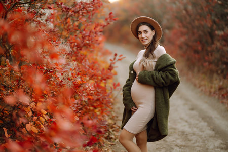 Beautiful pregnant woman feeling lovely in the park. Motherhood. Maternity. Lifestyle concept.の写真素材