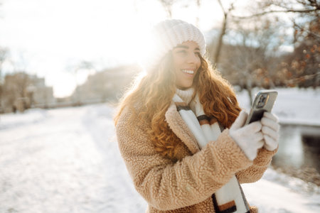 Young woman taking selfie in winter street. Holidays, rest, blogging.の写真素材