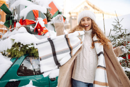Beautiful woman on a city street during the Christmas holidays. Christmas concept, holidays.の写真素材