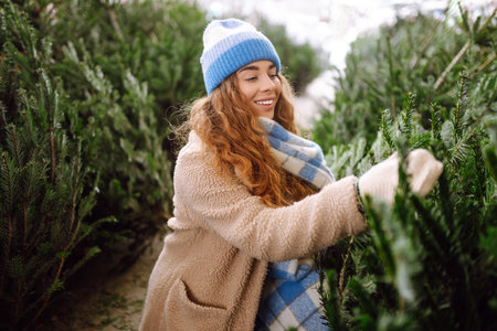 Happy woman buying a New Year tree for Christmas. Holiday concept, shopping.