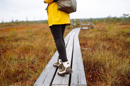 Hiking shoes of woman walking on wooden bridge. Copy Space on outdoor background. Active lifestyleの写真素材