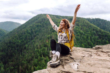 Traveler observes mountain scenery from cliff, view of European troll tongue. Concept of freedom.の写真素材