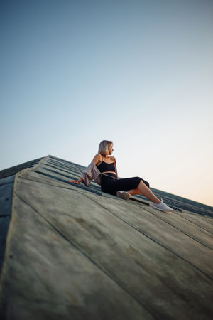 Person on roof enjoying sunset, freedom city atmosphere. Lifestyle, relaxation concept.の写真素材