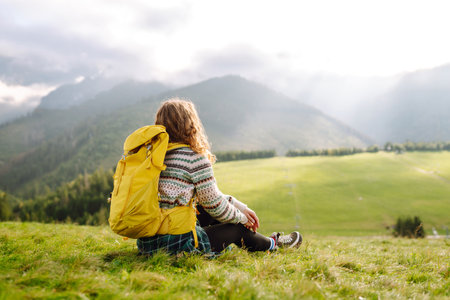 Young woman is having fun, walking through valley with stunning natural panorama. Adventure concept.