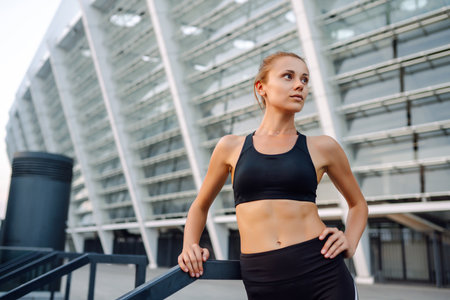 Portraits of a young sportswoman exercising outdoors. Concept of sport, active and healthy lifestyleの写真素材