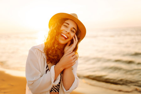 Happy woman on beach in summer style fashion trend outfit carefree and happy, feeling freedom.の写真素材