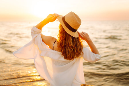 Happy woman on beach in summer style fashion trend outfit carefree and happy, feeling freedom.の写真素材