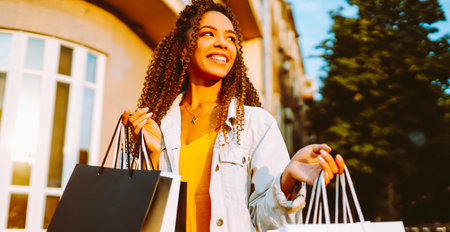 Young woman with shopping bags walking on street. , Sale concept.の写真素材