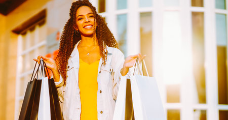Young woman with shopping bags walking on street. , Sale concept.の写真素材