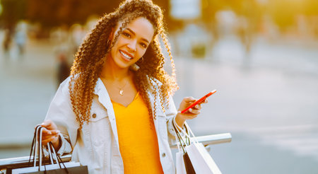 Young woman with shopping bags walking on street. , Sale concept.の写真素材