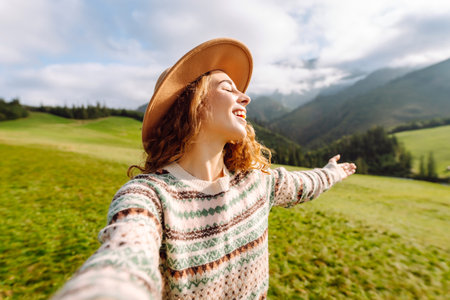 Close-up of a happy woman taking a selfie while hiking. Nature, adventure concept. Active lifestyle.の写真素材