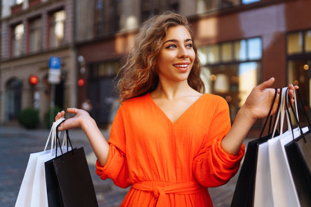 Young woman with shopping bags near mall. Purchases, shopping, lifestyle, sale concept.の写真素材
