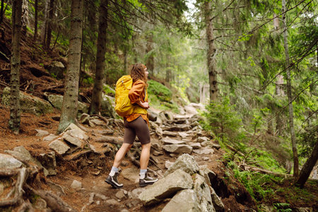 Young woman with backpack traveling outdoors. Hiking, active lifestyle.の写真素材
