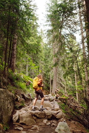 Young woman with backpack traveling outdoors. Hiking, active lifestyle.の写真素材