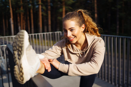 Beautiful woman outdoors and sportswear doing fitness. Concept of sport, recreation.の写真素材