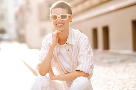 Beautiful woman in stylish clothes and short hair poses. Minimalism, urban style clothes.の写真素材