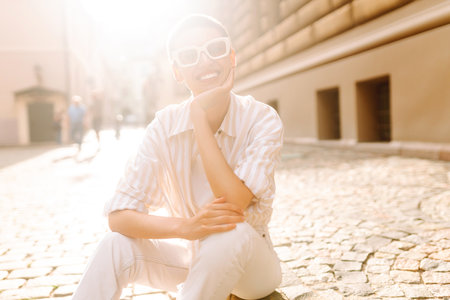 Beautiful woman in stylish clothes and short hair poses. Minimalism, urban style clothes.の写真素材
