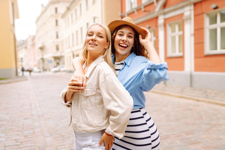 Two beautiful women having fun outdoors. Fun, weekend concept. Active lifestyle.の写真素材