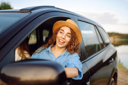 Two young women on car trip having fun. Lifestyle, travel, tourism, nature, active life.の写真素材