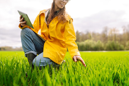 Innovative smart farm system technology, agricultural management. Farmer with tablet in green fieldの写真素材