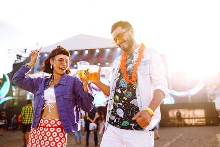 Couple with beer at music festival. Summer Beach party, holiday, vacation concept.の写真素材
