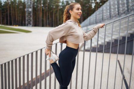 Strong woman doing exercises outdoors in the morning. Active life, healthy lifestyle.の写真素材