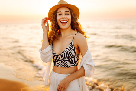 Happy woman on beach in summer style fashion trend outfit carefree and happy, feeling freedom.の写真素材