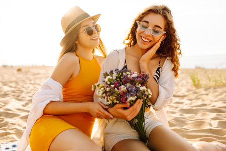 Two beautiful women enjoying on the beach. Female friends walking on the beach. Lifestyle concept.の写真素材