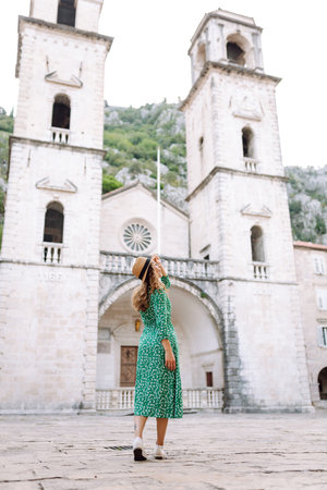 Happy female tourist in beautiful dress walking in the street of the city. Fashion style. Travel.の写真素材