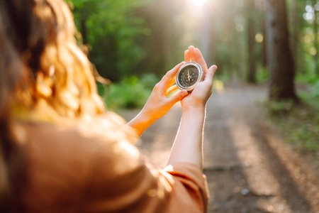 Hands of woman holding navigational compass. Female traveler holding compass in handsの写真素材
