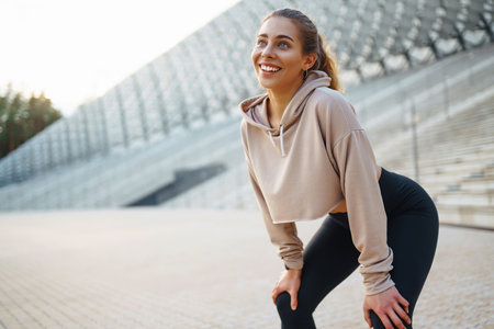 Athletic young woman training outdoors. Fitness woman stretching outdoors. Active lifestyle.の写真素材