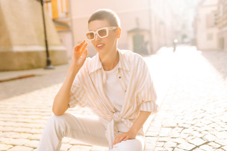 Beautiful woman in stylish clothes and short hair poses. Minimalism, urban style clothes.の写真素材
