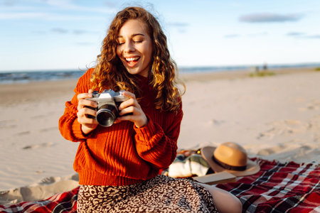 Happy woman with retro camera on the beach. Travel, weekend, relax and lifestyle concept.