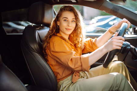 Stylish woman driving car. Traveler is the driver. Automobile travel. Sharing car. Lifestyle concept