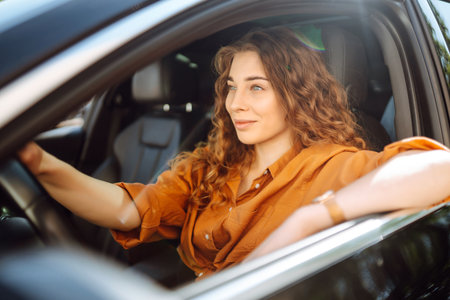 Stylish woman driving car. Traveler is the driver. Automobile travel. Sharing car. Lifestyle conceptの写真素材