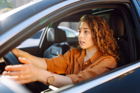 Stylish woman driving car. Traveler is the driver. Automobile travel. Sharing car. Lifestyle concept