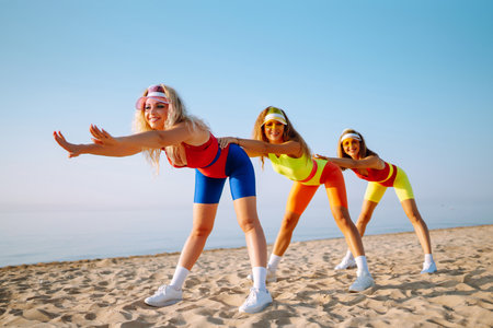 Dancing on the beach. Woman in colorful swimsuits are dancing in the morning. ?concept of fitness, aerobics.の写真素材