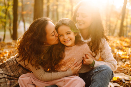 The family playing with their daughter in the autumn forest. The adventure is more fun.