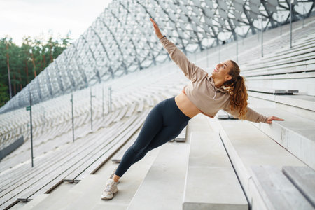 A young female athlete in special clothing is training on the court. Concept of sport, health.の写真素材