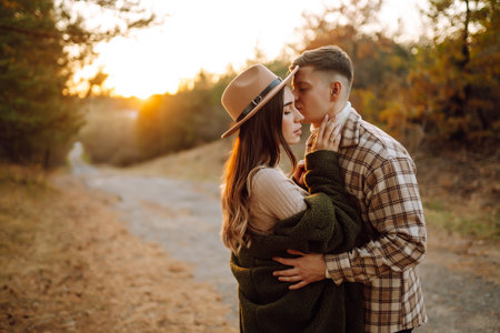 Happy couple in love newlyweds travel together, hike and walk in the autumn forest in nature.の写真素材